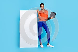 Photo of lady hold netbook direct thumb white vertical empty space poster wear brown shirt isolated blue color photo