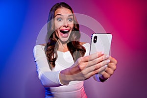 Photo of lady hold phone game tournament wager result reaction wear white shirt isolated neon gradient color background