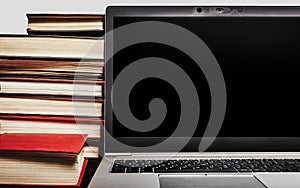 Photo of laptop with antique books