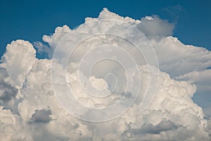 Photo of large white cumulonimbus cloud, summer thunderstorm in Guardo Tadino