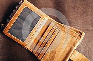 Photo of leather wallet laying on leather surface