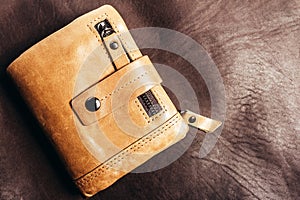 Photo of leather wallet laying on leather surface