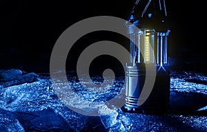 Photo of led camping lantern standing on ice