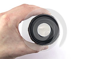 photo lens in hand at the lumen on a white background