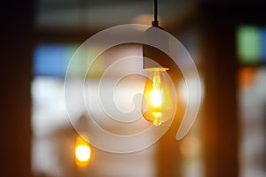 Photo of lights in cafe, restaurant or hotel. Fashion decoration with LED bulbs for party. Electric lamps indoors. Energy saving,