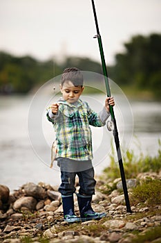 Photo of little boy fishing