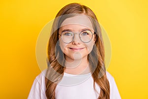 Photo of little cute blond girl wear spectacles white t-shirt isolated on yellow color background