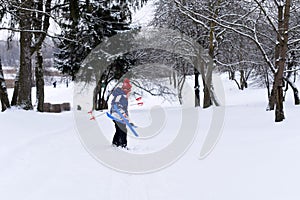 A photo of a little girl practicing skiing againts a beautiful winter landscape