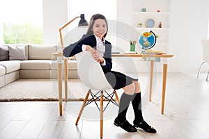 Photo of little pretty student girl good mood return school online way learning sitting chair table desk wear uniform