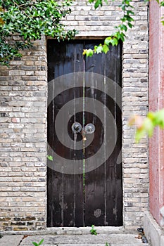 A locked wooden door in traditional Chinese style