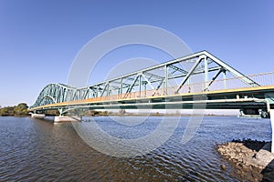 Photo of a long steel bridge over a river. photo
