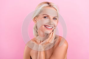 Photo of lovely adorable retired lady nude shoulders enjoying her perfect young skin  on pink color background