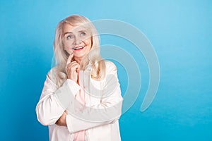 Photo of lovely charming aged woman look empty space guess dream isolated over blue color background