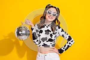 Photo of lovely clubber girl in spotted shirt hold disco ball having fun isolated shine color background