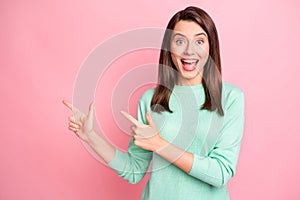 Photo of lovely crazy girl direct finger empty space open mouth wear teal sweater isolated pink color background