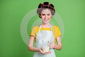 Photo of lovely cute young hospitable girl roller hairstyle beaming smiling hold jar give cold fresh milk tired traveler