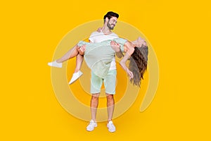 Photo of lovely dream couple handsome man hold gorgeous spouse wear casual outfit isolated yellow color background