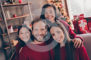 Photo of lovely family hug sit on couch wear red jumper indoors near tree on x-mas eve
