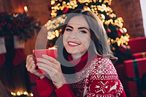 Photo of lovely positive girl toothy smile arms hold hot coffee cup enjoy magic spirit house indoors