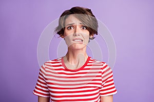 Photo of lovely young girl horrified face bite lip wear striped t-shirt isolated violet color background