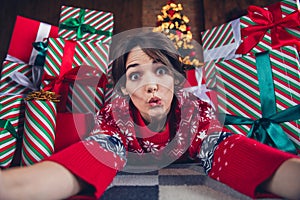 Photo of lovely young lady impressed lying floor selfie photo dressed stylish red sweater christmas tree decorated