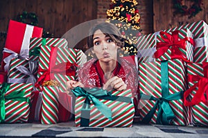 Photo of lovely young lady pull ribbon open gift impressed dressed stylish red sweater christmas tree decorated interior