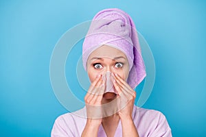 Photo of lovely young woman hands hold pink napkin nose wear purple towel turban bath robe isolated blue color