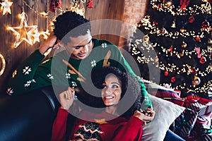 Photo of loving married people enjoy christmas time in festive event occasion lying couch in decor illuminated flat