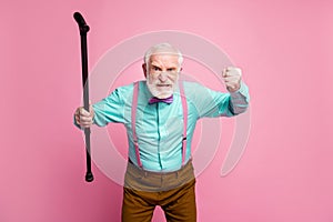 Photo of mad aged man raise walking cane fist angry grimace blaming neighbor kids for noisy behavior wear shirt