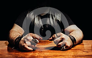 Photo of a male biker sitting by a wooden table