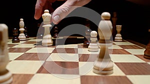 Photo of male hand holding chess figure
