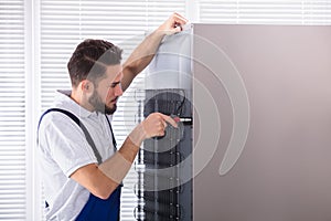 Technician Fixing Refrigerator