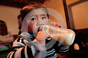A child drinking a bottle milk