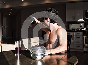 Photo of a man capturing a self-portrait at a table in the morning light