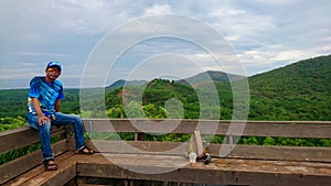 photo of a man from a height with a mountain view