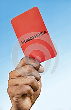 Man holding out a Homophobia red card photo