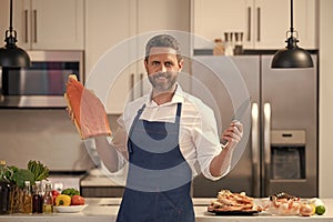 photo of man smile and cook delicacy salmon. man cook delicacy salmon.