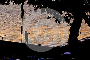 Photo of a man somewhere at seashore in contrasting evening light