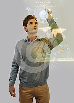 Photo manipulated shot of a young man using a theoretical digital interface..All screen content is designed by us and