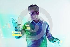 Photo manipulated shot of a young man using a theoretical digital interface.All screen content is designed by us and not