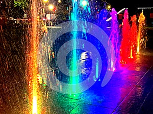 Many Rich Colorful Water Fountain Jets at Night