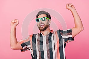 Photo of mature age man bearded raised fists up wearing sunglasses celebrate drunk summer party isolated on pastel pink