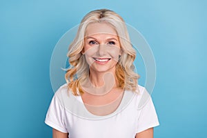 Photo of mature attractive woman happy positive toothy smile ceramic veneers clinic isolated over blue color background
