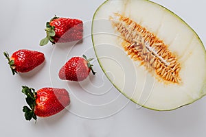 Photo of melon beside strawberries