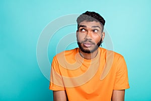 Photo of minded creative person look interested empty space contemplate isolated on teal color background