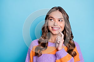 Photo of minded happy young lady hold finger think look empty space isolated on pastel blue color