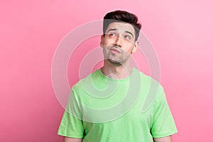 Photo of minded nice man wear trendy green clothes look up empty space hmm dilemma isolated on pink color background