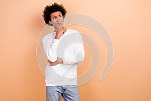 Photo of minded serious man wear white stylish sweater arm touch face look empty space poster isolated on beige color