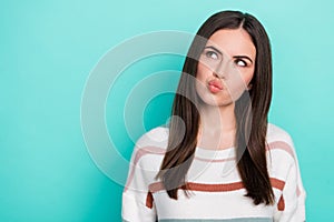 Photo of minded uncertain clever lady look empty space think wear striped pullover isolated blue color background