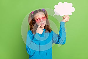 Photo of minded young thoughtful girl look hold hand cloud bubble minded isolated on green color background